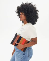 Candice carries the Suede / Nappa / Rustic Patchwork Flat Clutch 