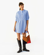 Danica wearing the Blue & Cream Stripe Le Tux Dress with tall black boots