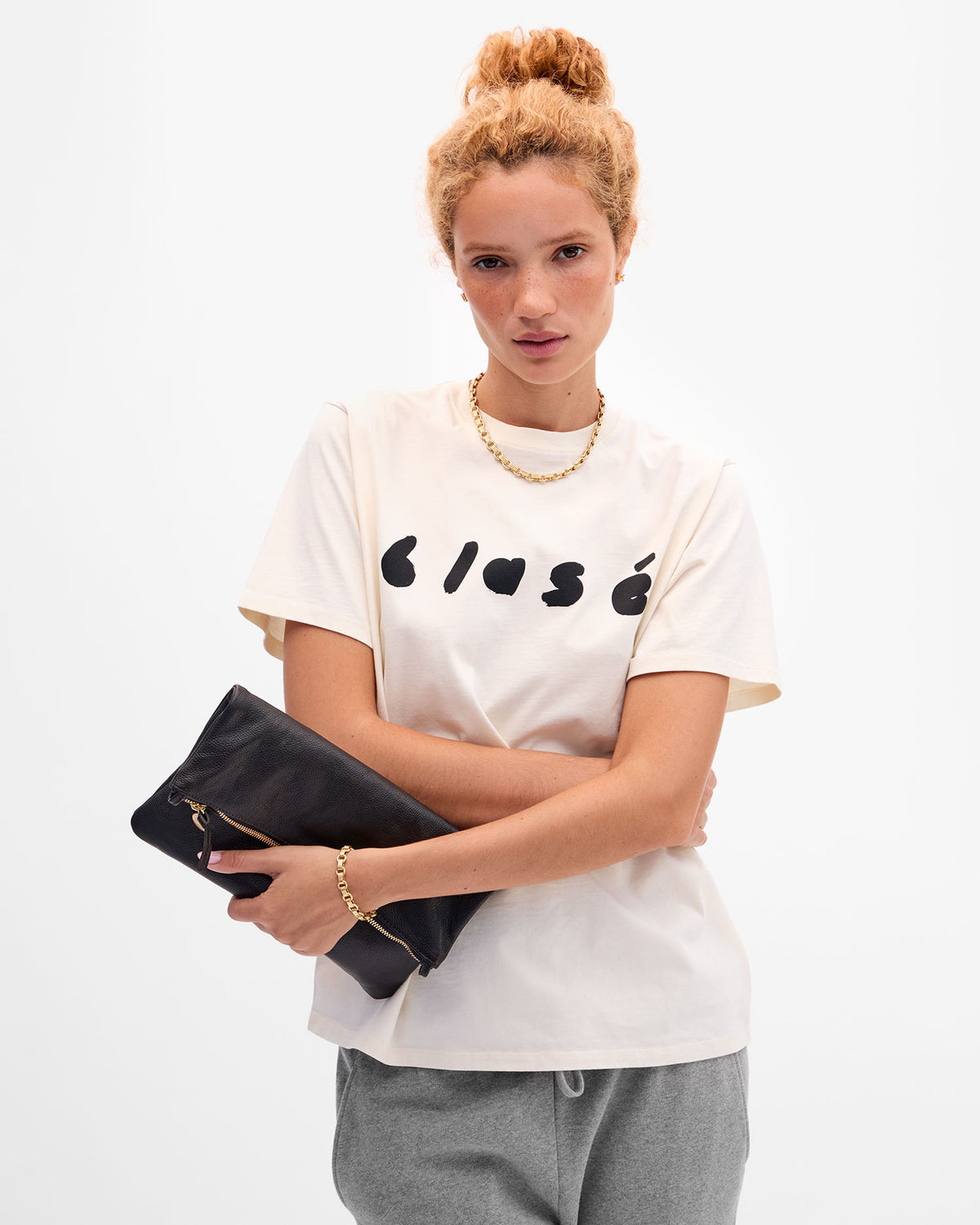 Laura holding Foldover Clutch