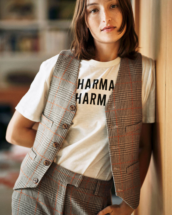 Zoe wearing the Cream w/ Black Charmant Tee with the suit pants and gilet 