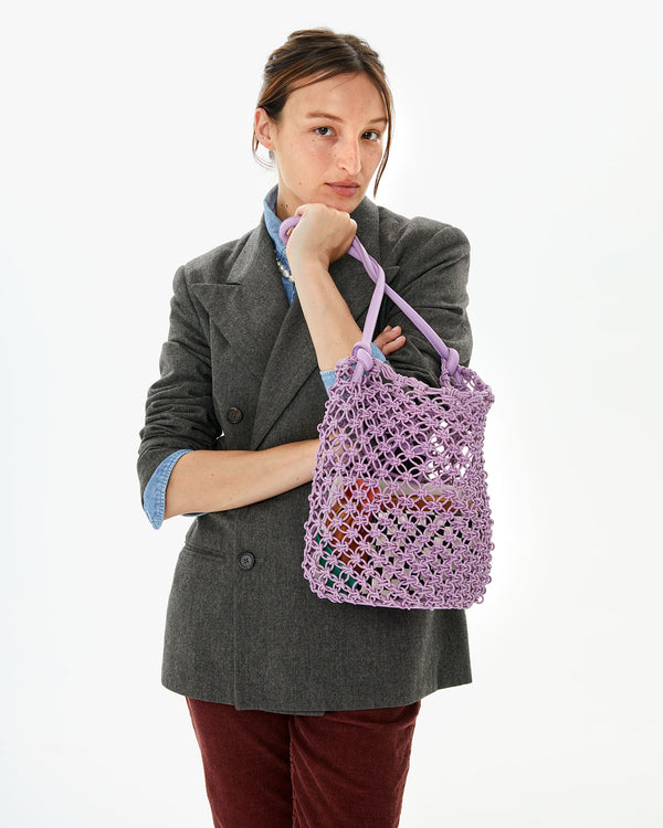 Zoe with her arms crossed, holding the Lilac Georgette under her chin