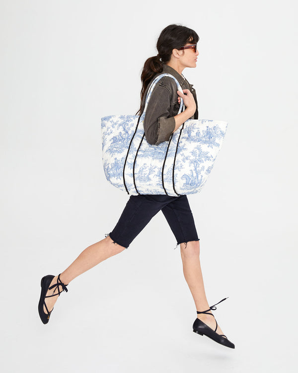 Danica carrying the St. Calais Blue Quilted Linen Toile Giant Trop Avion. with Pochette (Pochette not shown) over her shoulder.