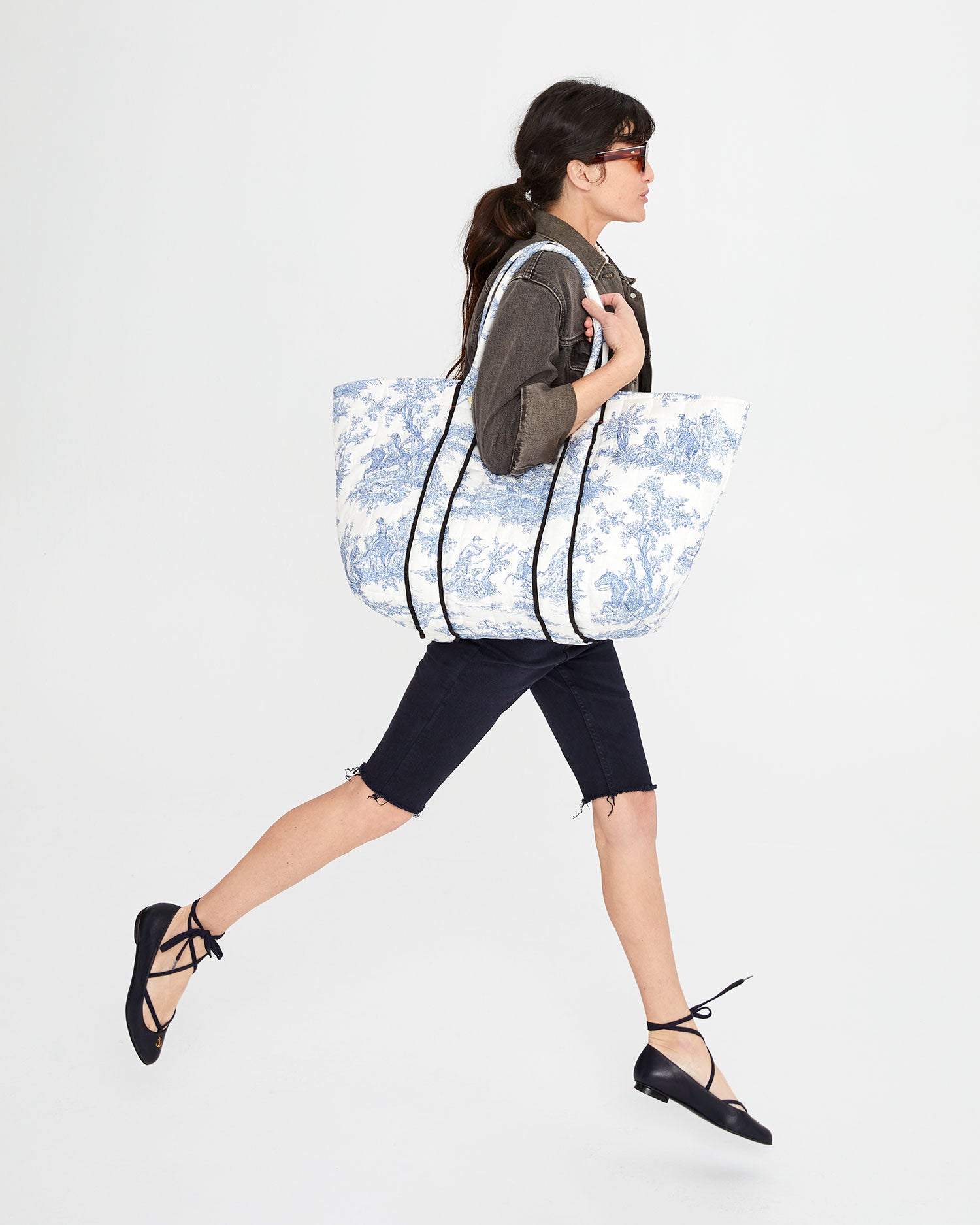 Danica carrying the St. Calais Blue Quilted Linen Toile Giant Trop Avion. with Pochette (Pochette not shown) over her shoulder.