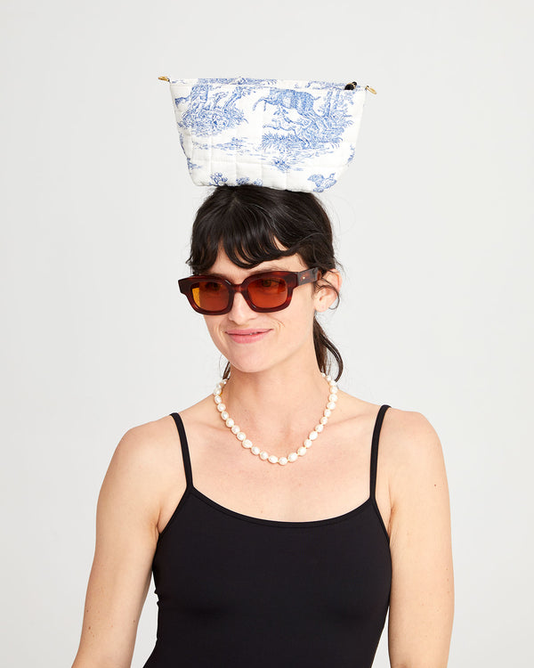 Danica with the St. Calais Blue Quilted Linen Toile Pochette on top of her head.
