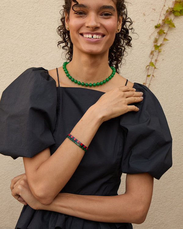 Haro wearing the Emerald Beaded Glass Strand Necklace with a black poof sleeve top