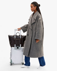 Grand Zip Sac on suitcase