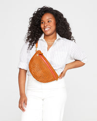 Candace wears the Tan Rattan Grande Fanny as a cross-body, using our extended belt. 