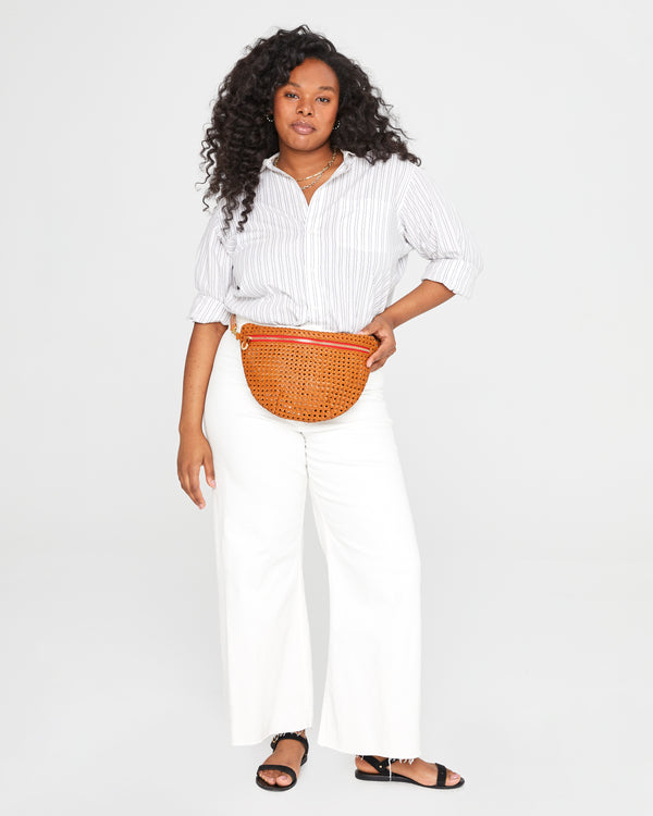 Candace wears the Tan Rattan Grande Fanny at her waist. 