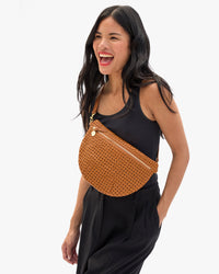 Model carrying the Tan Rattan Grande Fanny across her chest.