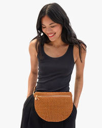 Model carrying the Tan Rattan Grande Fanny around her waist.