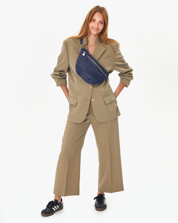 Aurelia with her hands on her hips on Pacific Woven Zig Zag Grande Fanny across her chest 