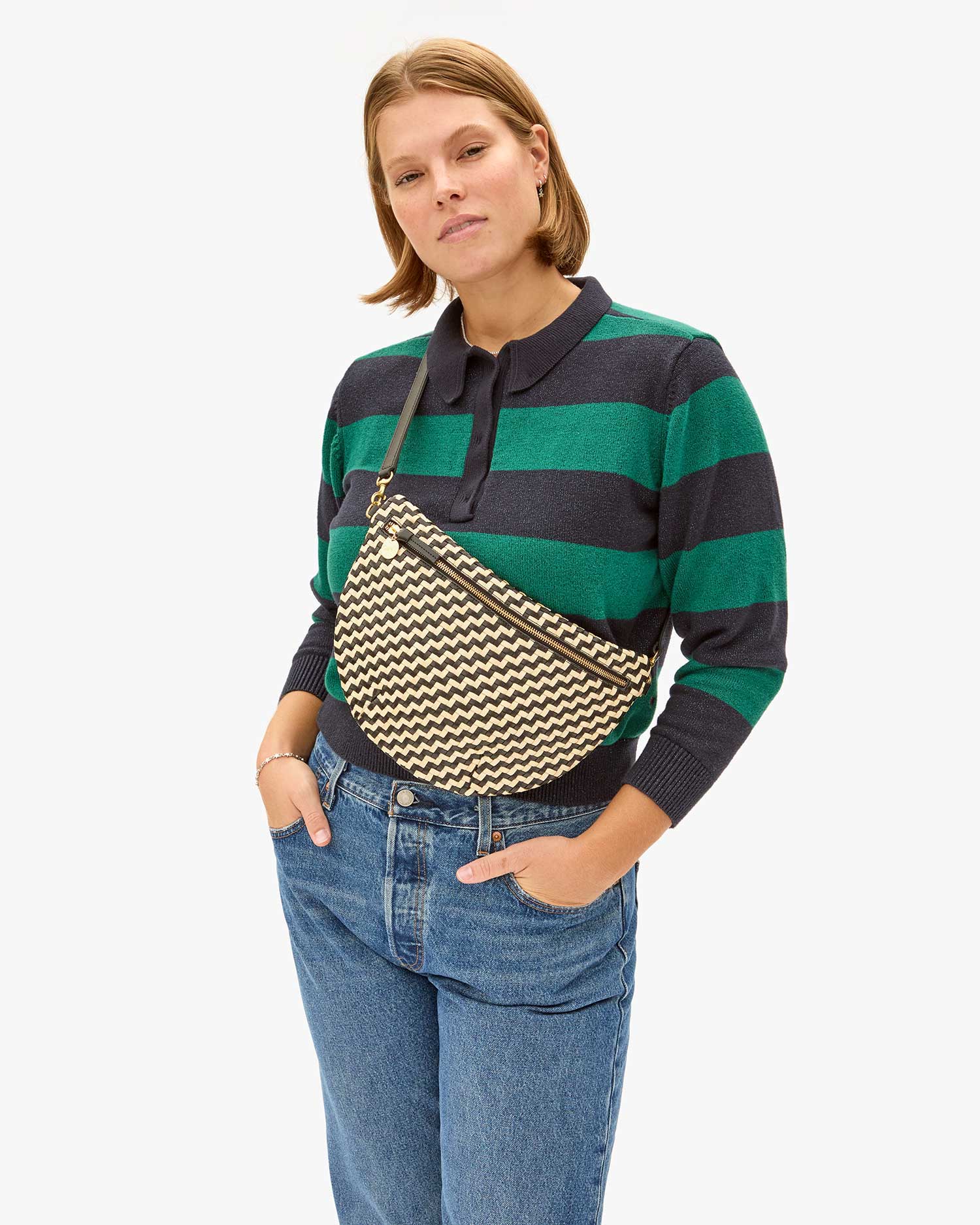 Sonnie wearing the Black & Cream Woven Zig Zag Grande Fanny across her chest over the Heloise polo sweater