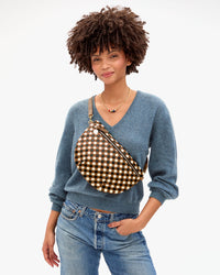 Model carrying the Oat Multi Diagonal Woven Grande Fanny over her chest.