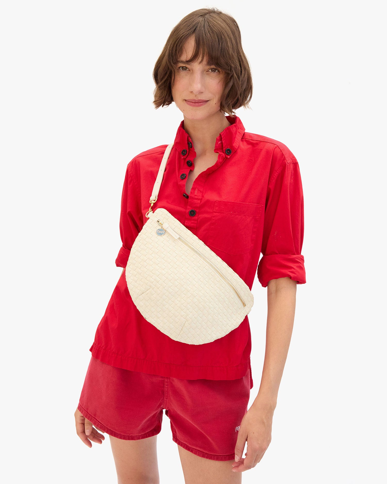 Kathie wears the Grande Fanny in Cream Woven Checker as a Crossbody