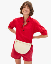 Kathie wears the Grande Fanny in Cream Woven Checker as a Belt Bag around her waist