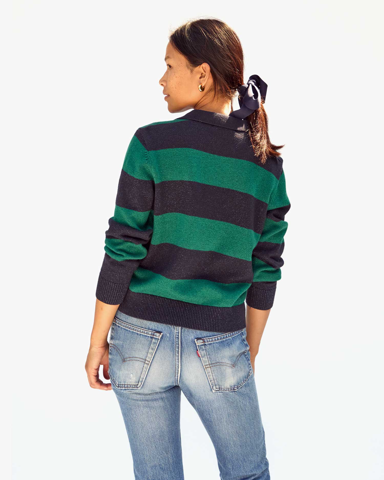 back view of Maly in the Navy & Green Stripe Heloise Polo Sweater with jeans