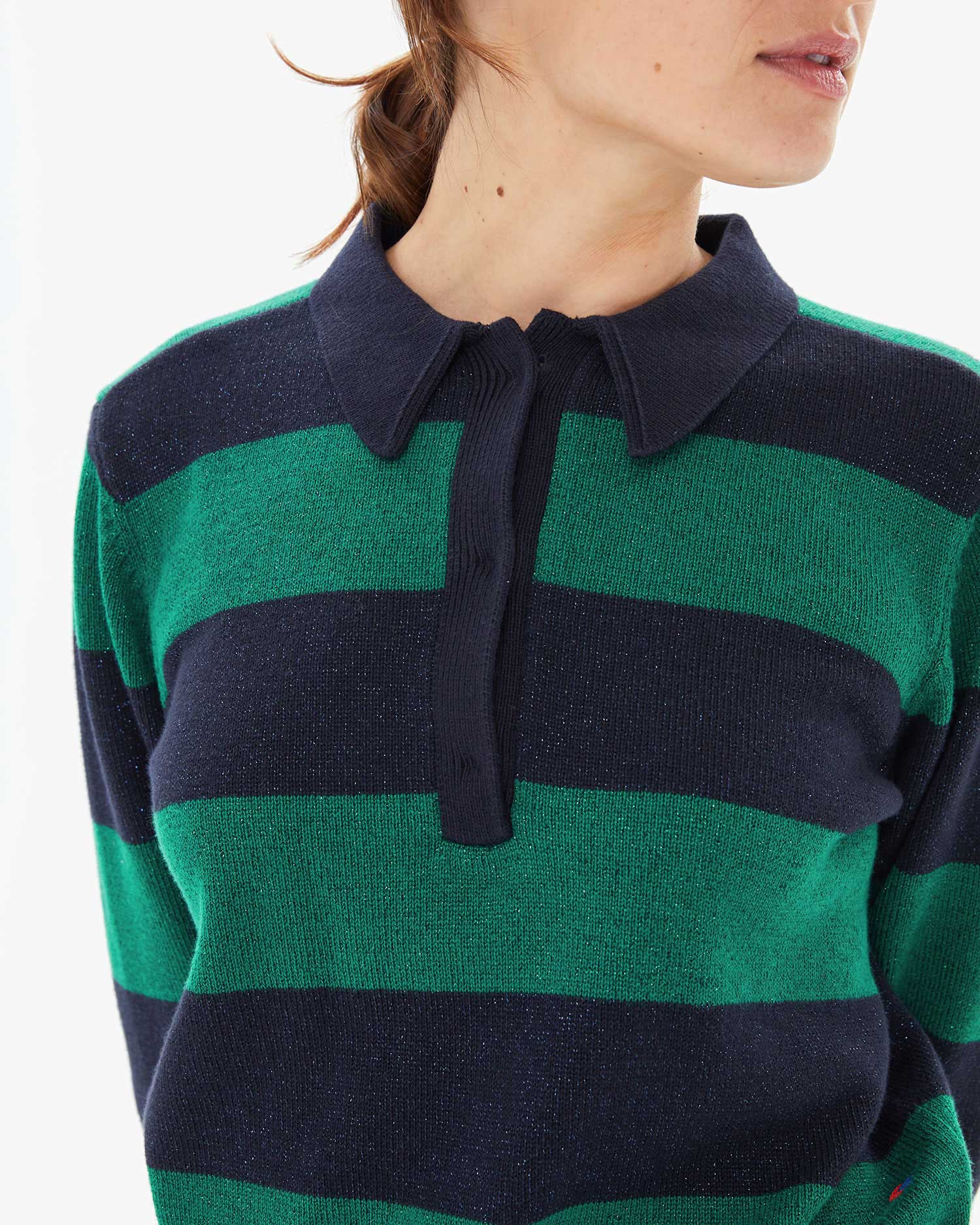 close up of the button placket on the Navy & Green Stripe Heloise Polo Sweater worn by Zoe