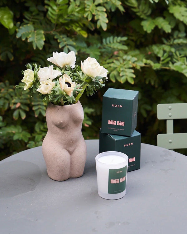 Roen Candle in the scent Hotel Flori next to the candle's box