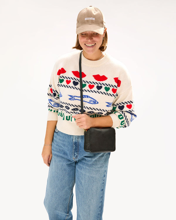 Sonnie wearing the Cream w/ Multi Icon Intarsia Icon Sweater with a CV hat and a Midi Sac