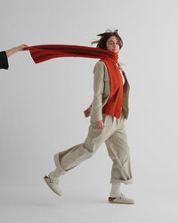 Model wearing the Poppy & Cumin Brushed Vertical Stripes Scarf with an all neutral outfit 