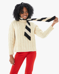 Mecca wearing the Black and Oatmeal Stripe Scarf with a scream sweater and red pants