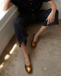 model wearing the Jamie Haller Ballet Slip in Bronzo with jeans