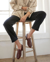 model wearing the Jamie Haller Brown Croc Embossed Penny Loafer  with black jeans