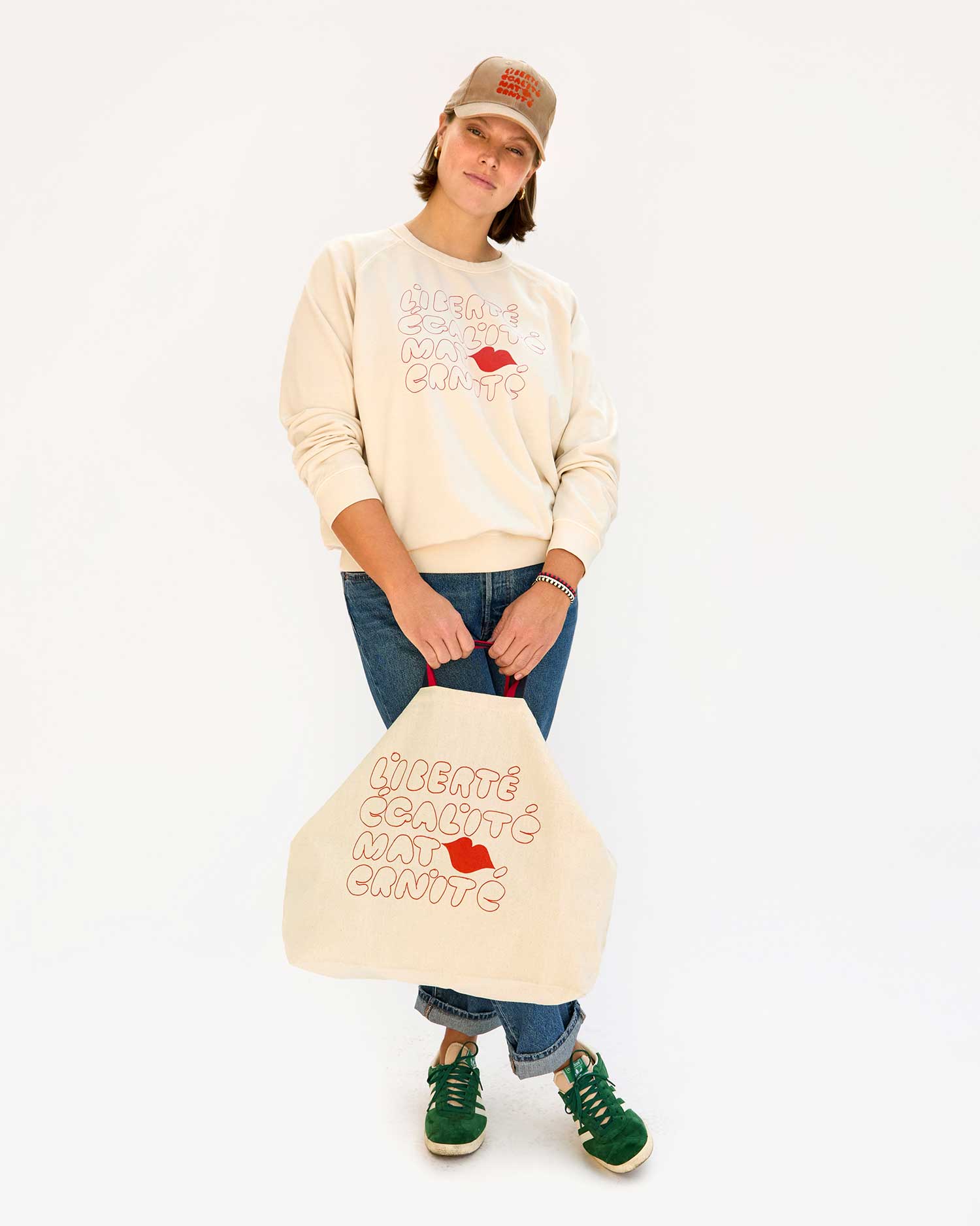 Sonnie wearing the Tan Corduroy w/ Liberte Egalite Maternite Baseball Hat with the EMC Sweatshirt and carrying the matching EMC Jumbo Tote.
