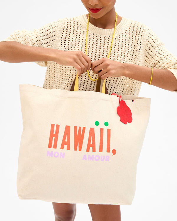 Model holding the Hawaii, Mon Amour Jumbo Tote by the top handles. 