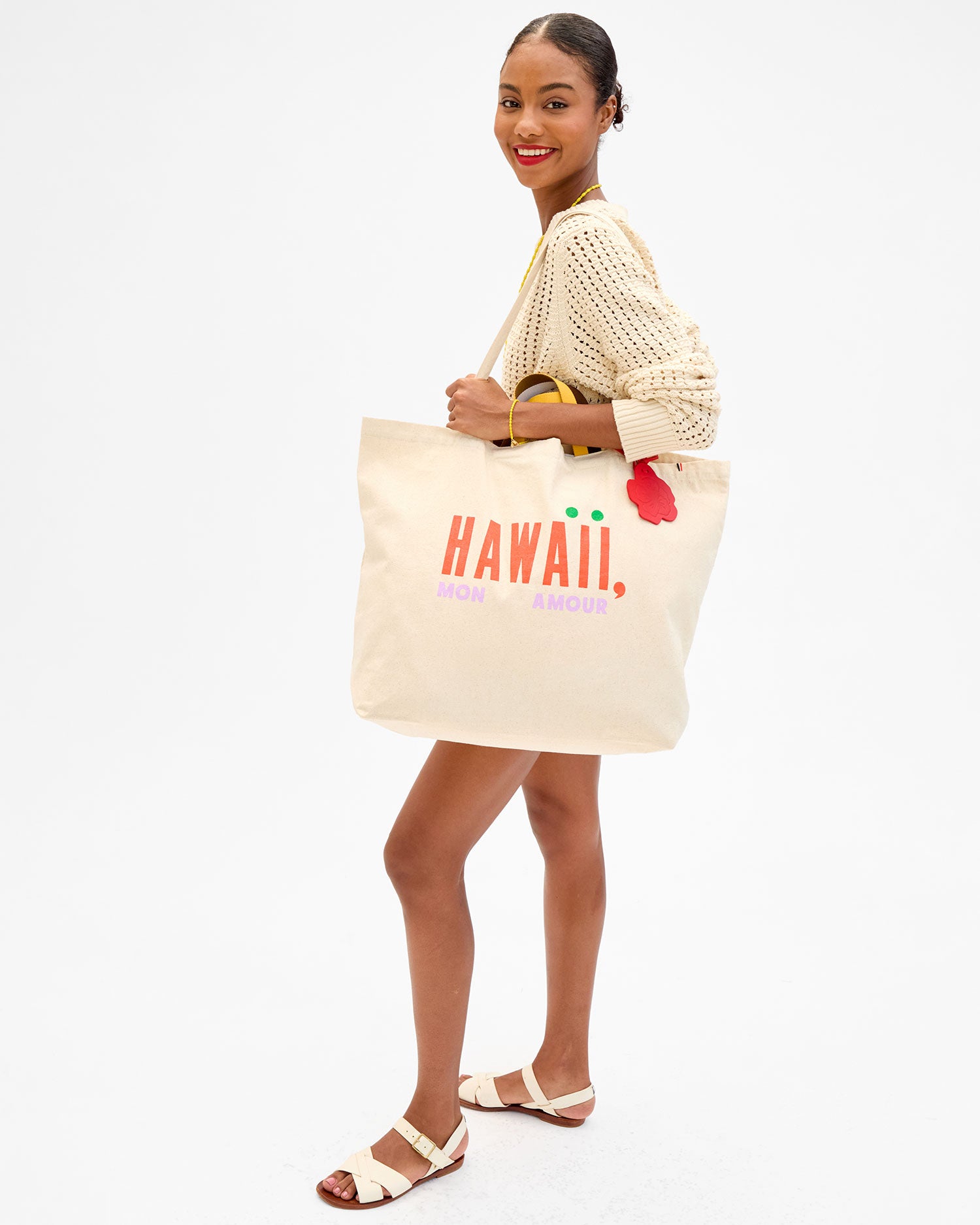 Model carrying the Hawaii, Mon Amour Jumbo Tote with the Hibiscus Fob attached to it. 