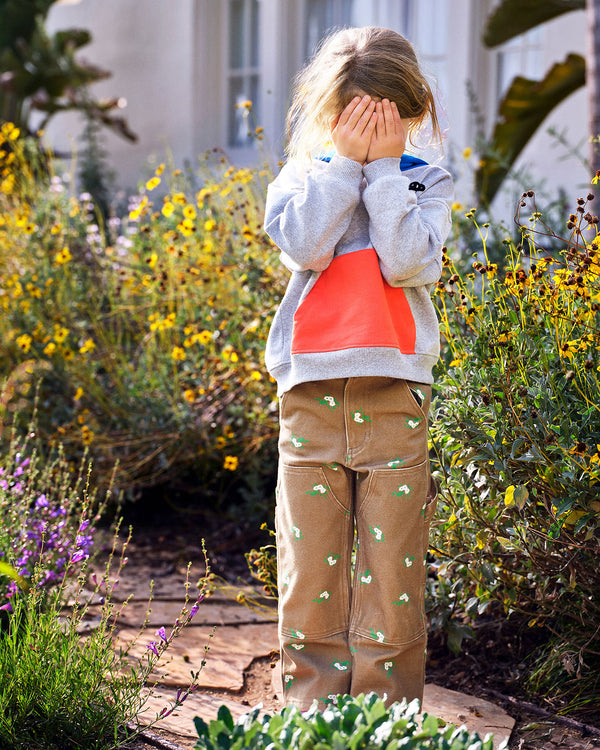 model wearing the Grey w/ Poppy & Cobalt Kids Hoodie with her hands in front of her face