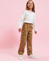 Model wearing the Khaki Kids Pants with the cream charmant longsleeve tee
