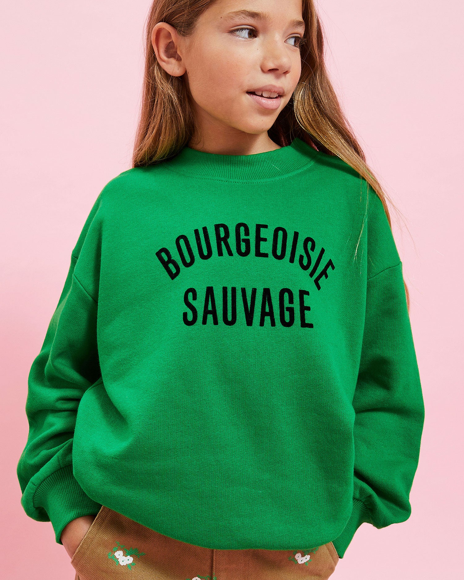 model wearing the Green w/ Black Bourgeoisie Sauvage Kids Sweatshirt with the khaki kids pants