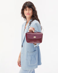 Danica holding top handle of Kathryn