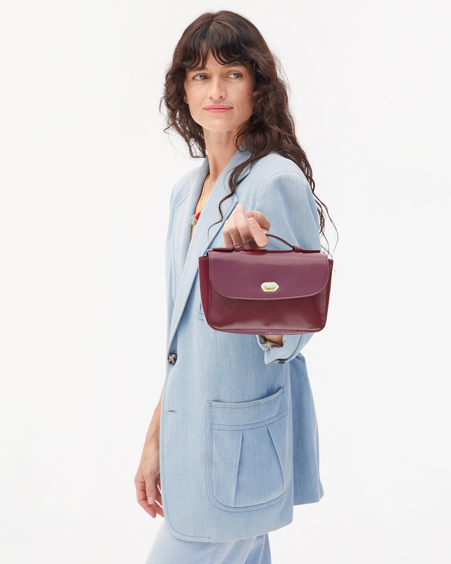 Danica holding top handle of Kathryn