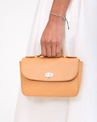 Vie holds Kathryn by the top handle