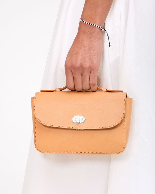 Vie holds Kathryn by the top handle
