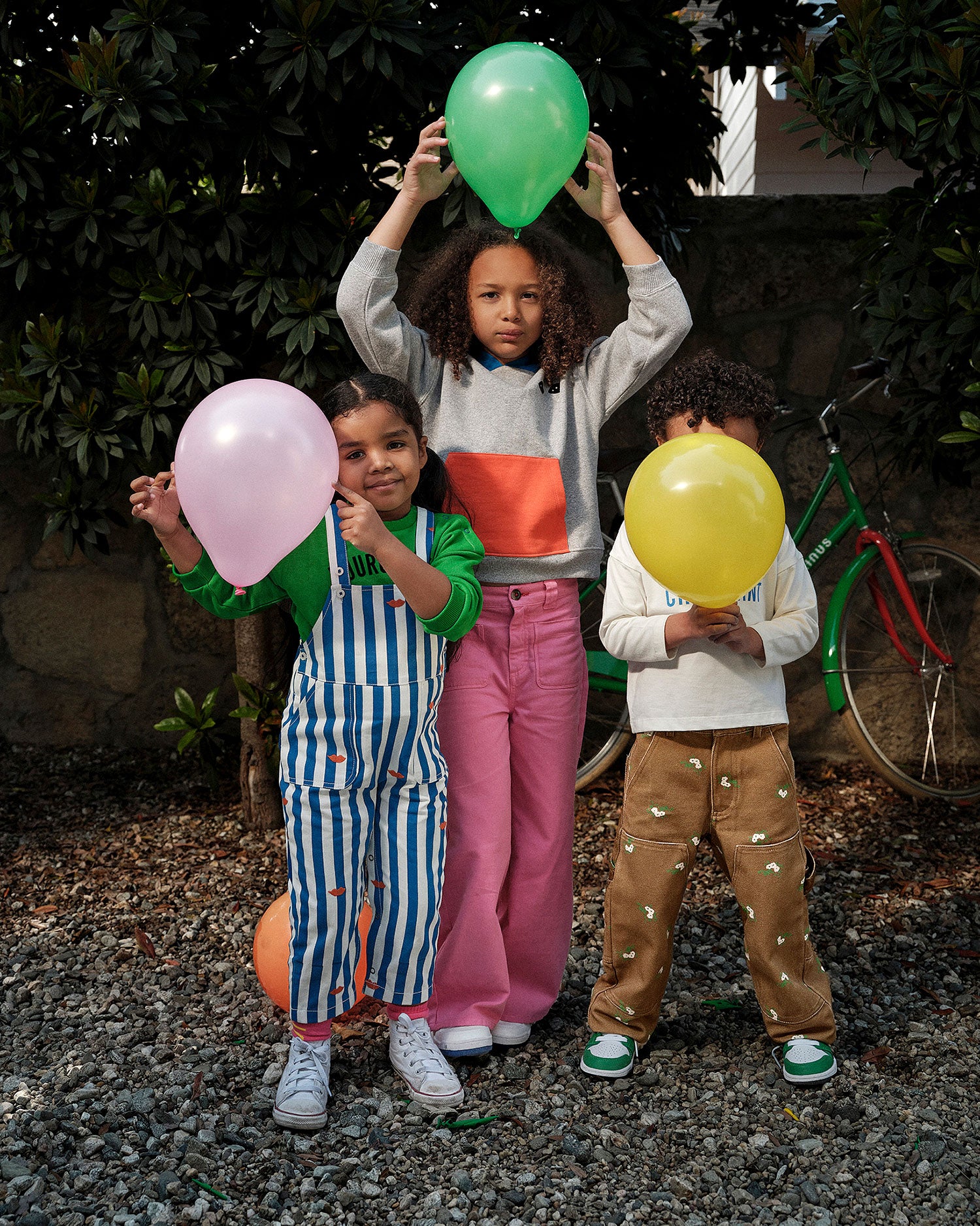 Group of kids playing with balloons. Child on the right wears the kids khaki pants