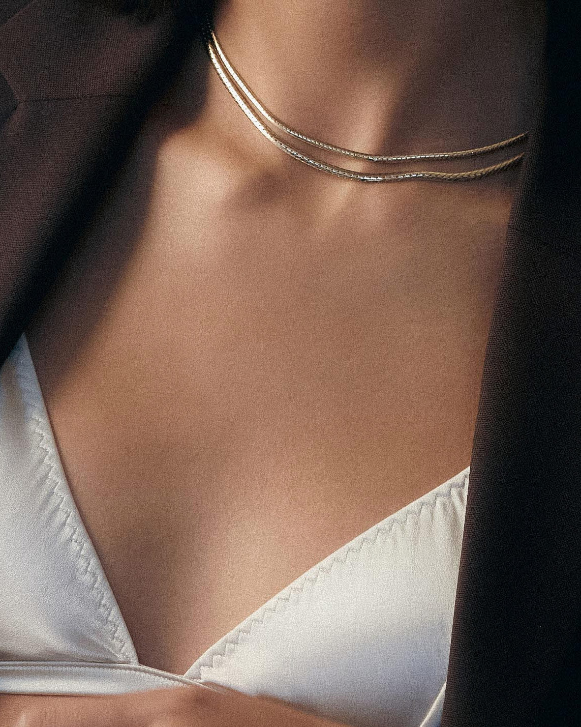 Model wearing the Kennedy Herringbone Chain I with a white satin bralette