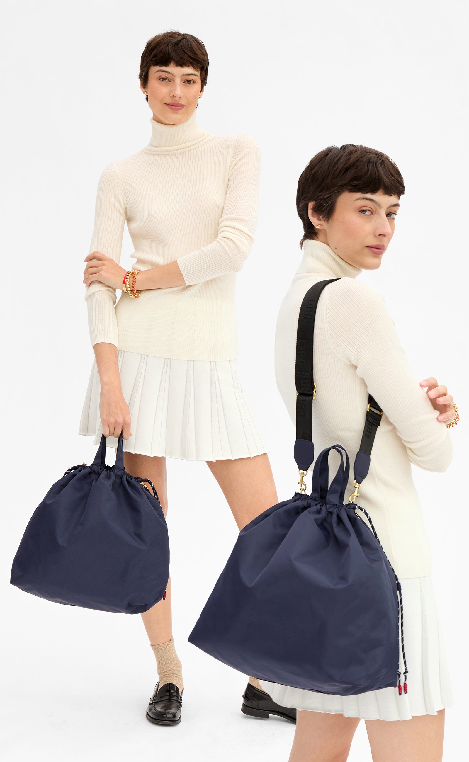 Model wearing a cream skirt with matching top and carrying the Navy Sac Tout. 
