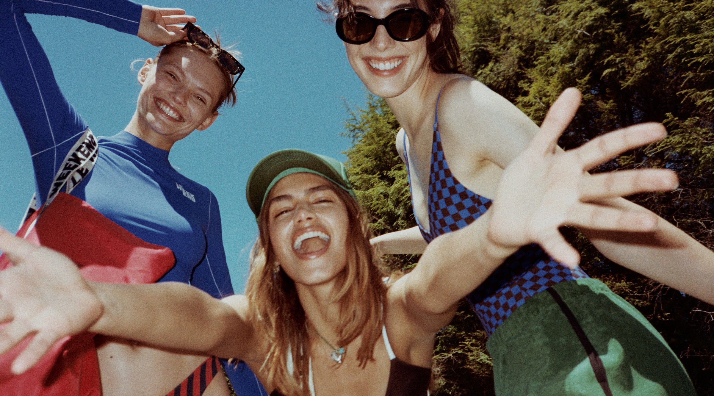 Three models wearing CV x LOF and taking a picture together. 