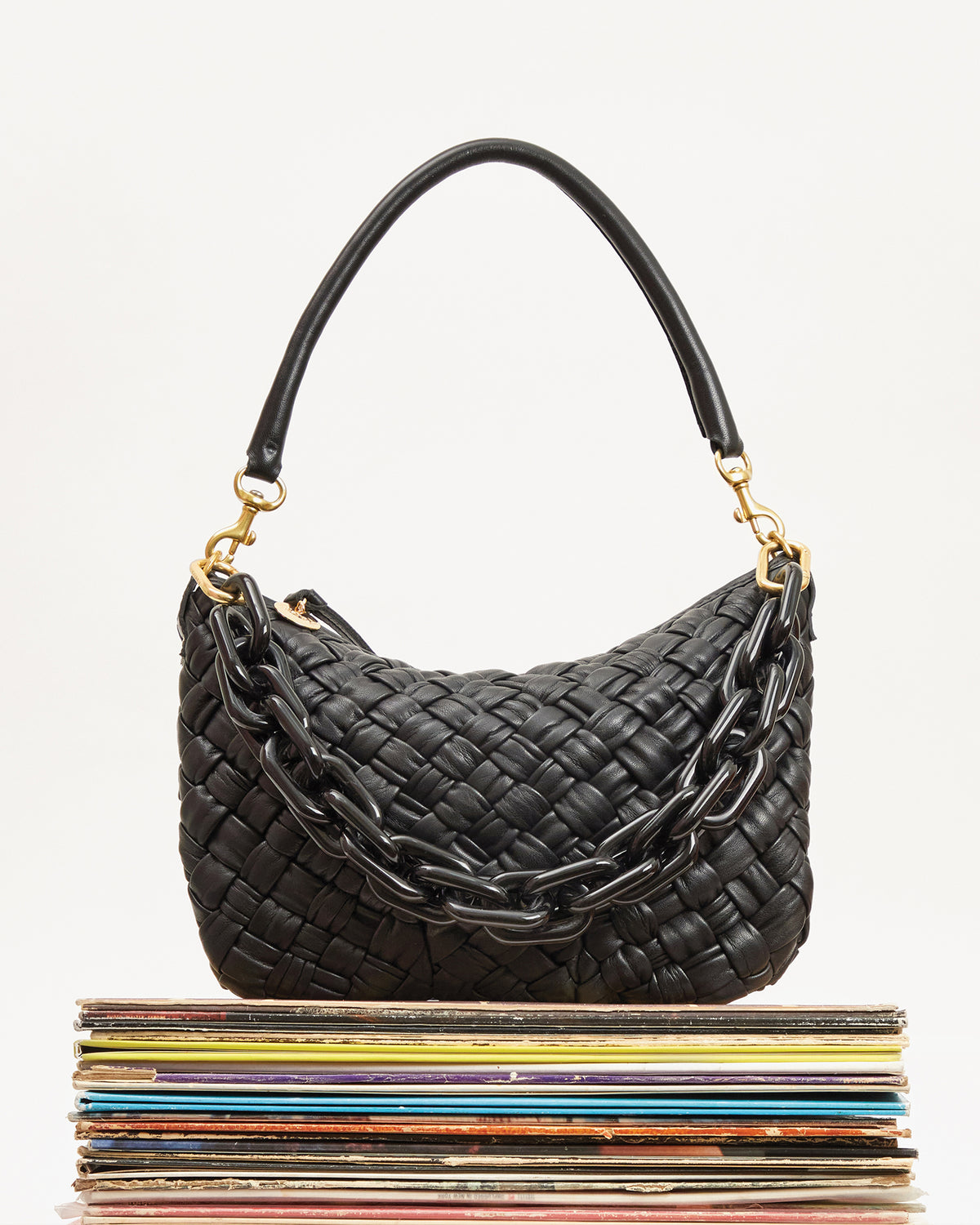 Black Puffy Woven Petit Moyen with a Black Shortie Strap attached to it. 