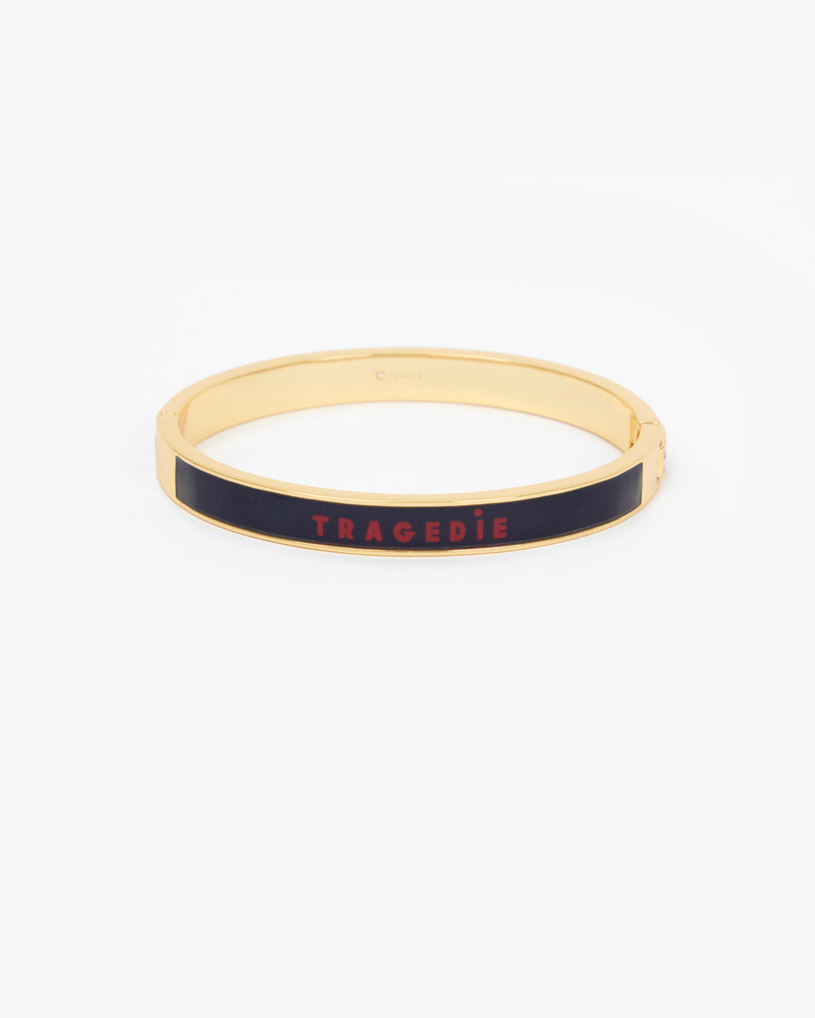 Le Bangle Bracelet featuring a black enamel inlay with the word 'TRAGEDIE' in red lettering.