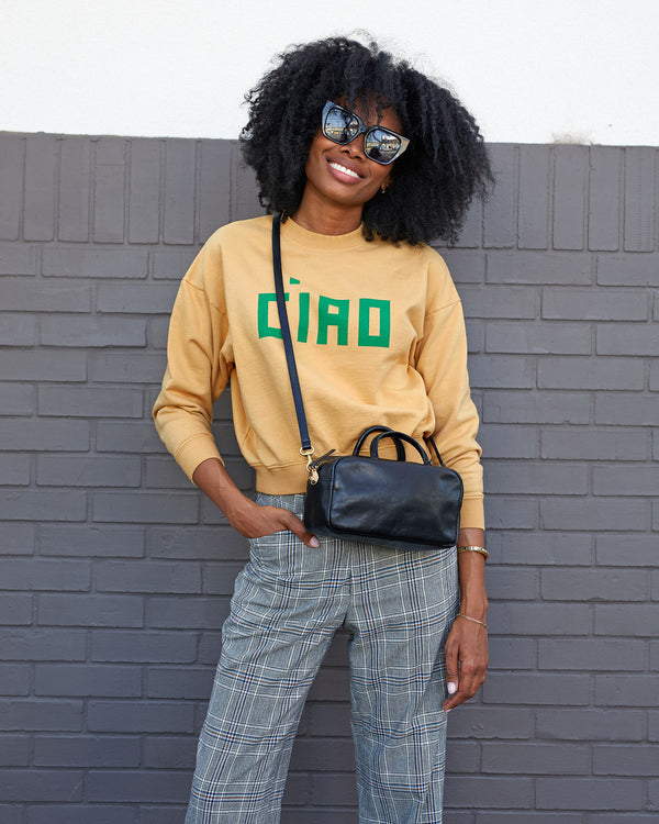 mecca wearing the oat ciao le drop sweatshirt with plaid pants