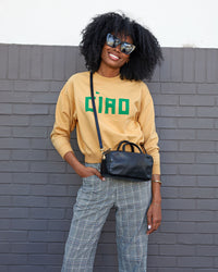 mecca wearing the oat ciao le drop sweatshirt with plaid pants