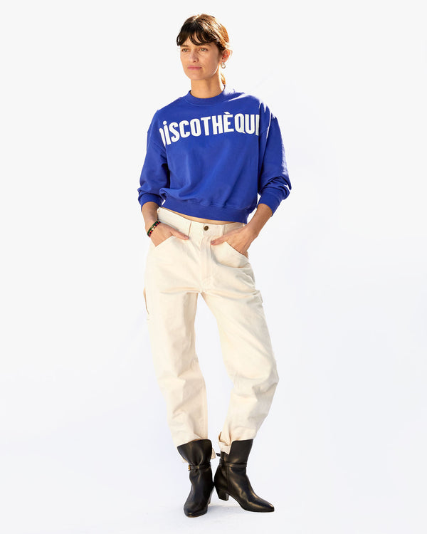 Danica in white pants and black boots with the Cobalt Discothèque Le Drop