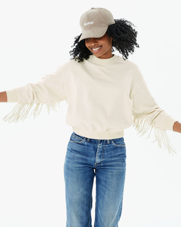 Mecca in jeans and the Cream Le Drop Fringe with the stone baseball hat