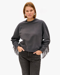 Sonnie wearing the charcoal le drop fringe with black jeans 