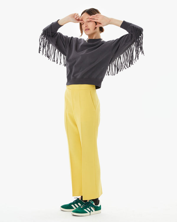Zoe stretching to show off the fringe on the le drop fringe in charcoal 