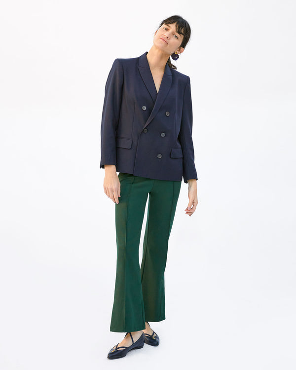 Danica wearing the Le Flare in Forest with a navy blazer